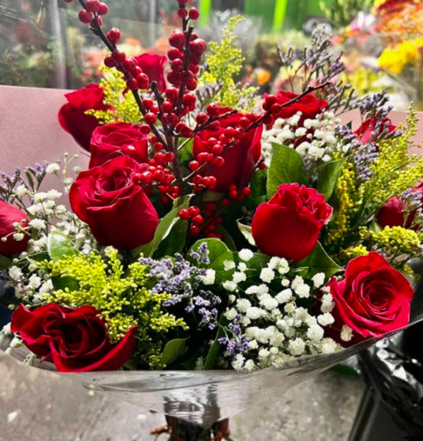 Red roses and red berries bouquet